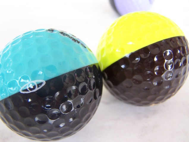 Brown and Yellow Ping ball beside an Aqua and Black Ping