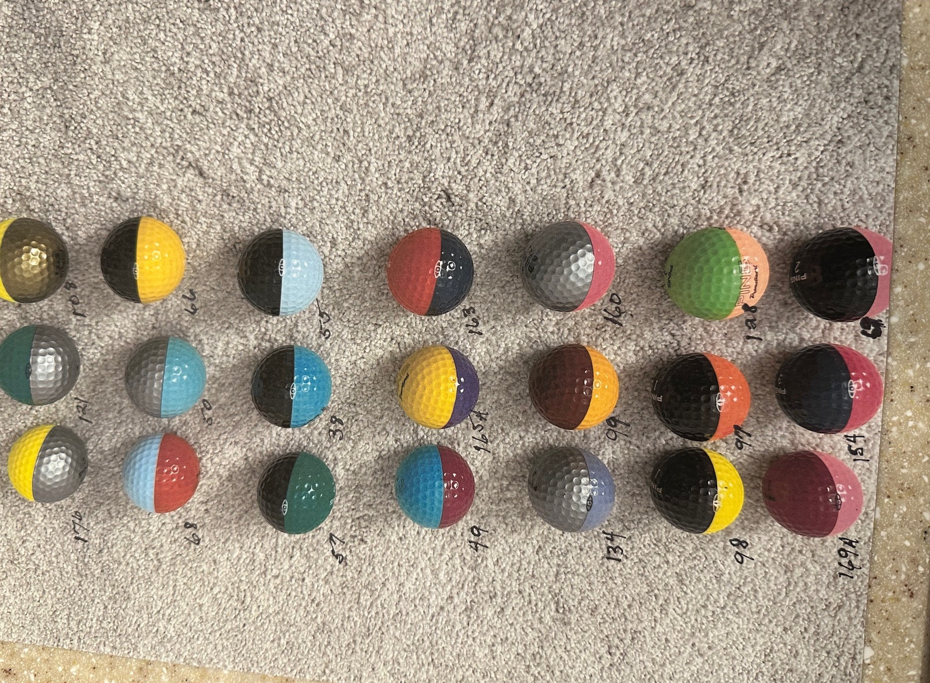 Ping golf balls catalog numbers in the 100s range showing two-tone color combinations